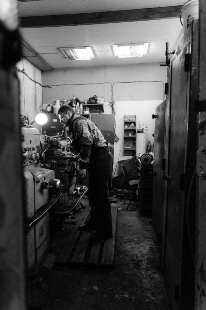 pexels-photo-5846272-5846272 Grayscale Photo of a Man Using a Lathe Machine